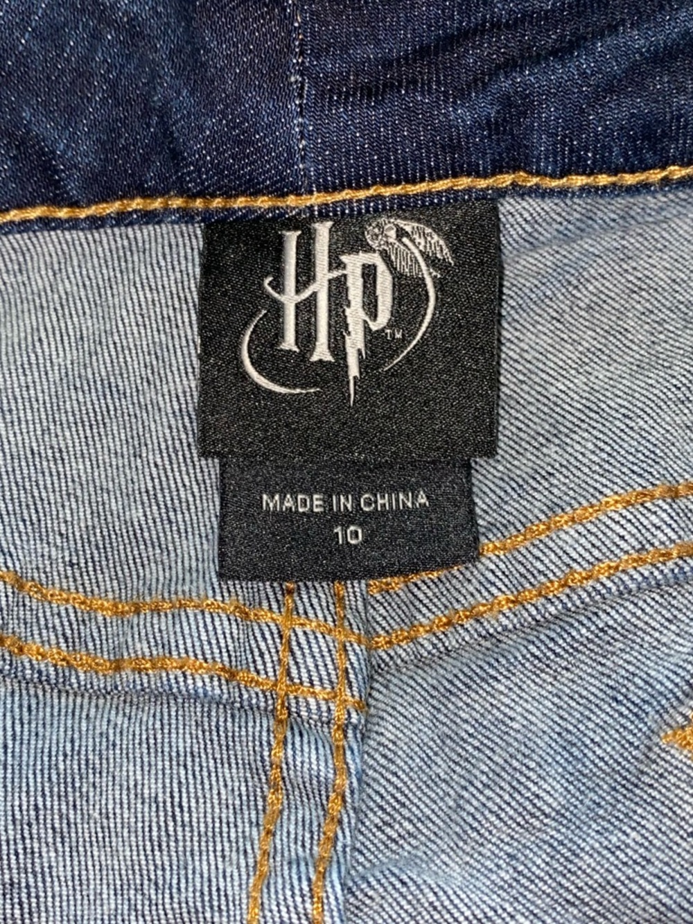 HARRY POTTER Denim Raw Hem Shorts Featuring Embroidered Hogwarts Patches - Picture 4 of 4